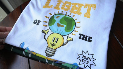 Light of the World featuring happy lightbulb holding the world, Bible verse John 8:12 scripture, white t-shirt, front pocket logo